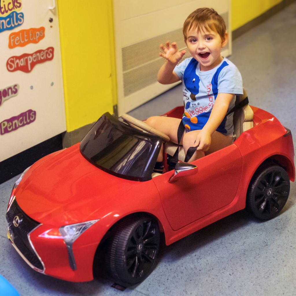 Child Driving red lexus car