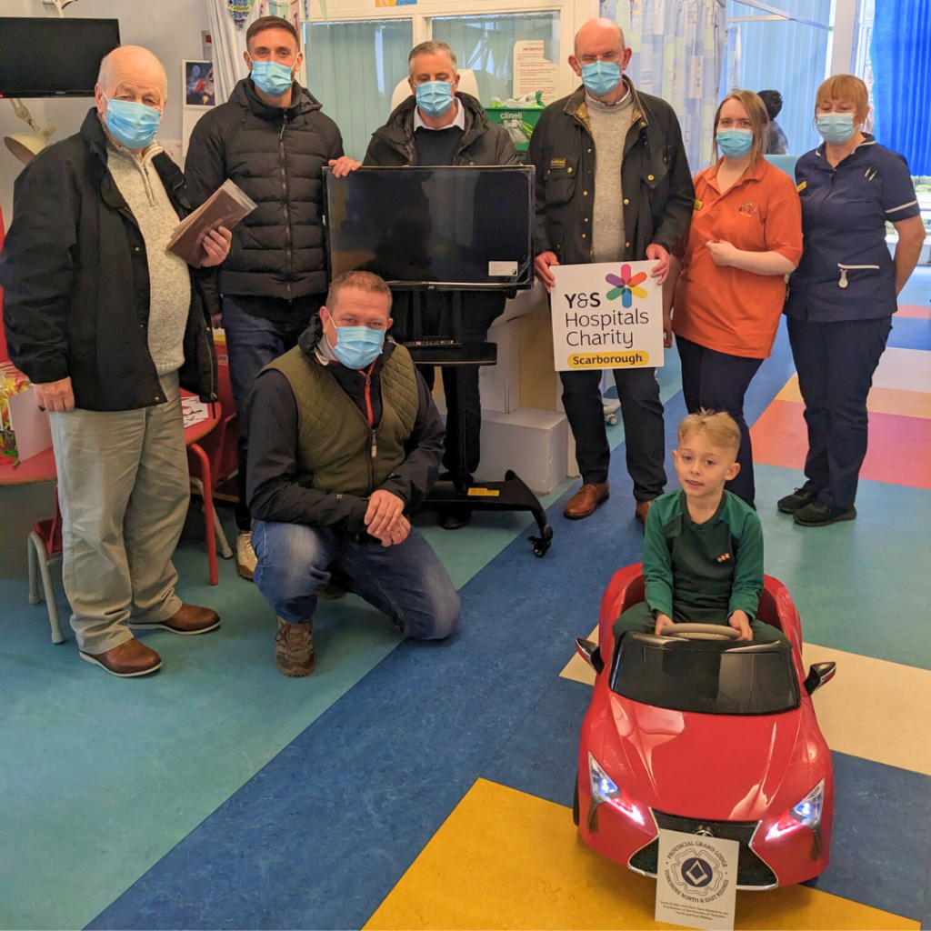 Bridlington Freemasons handing over the electric car to the Children's Ward at Scarborough Hospital