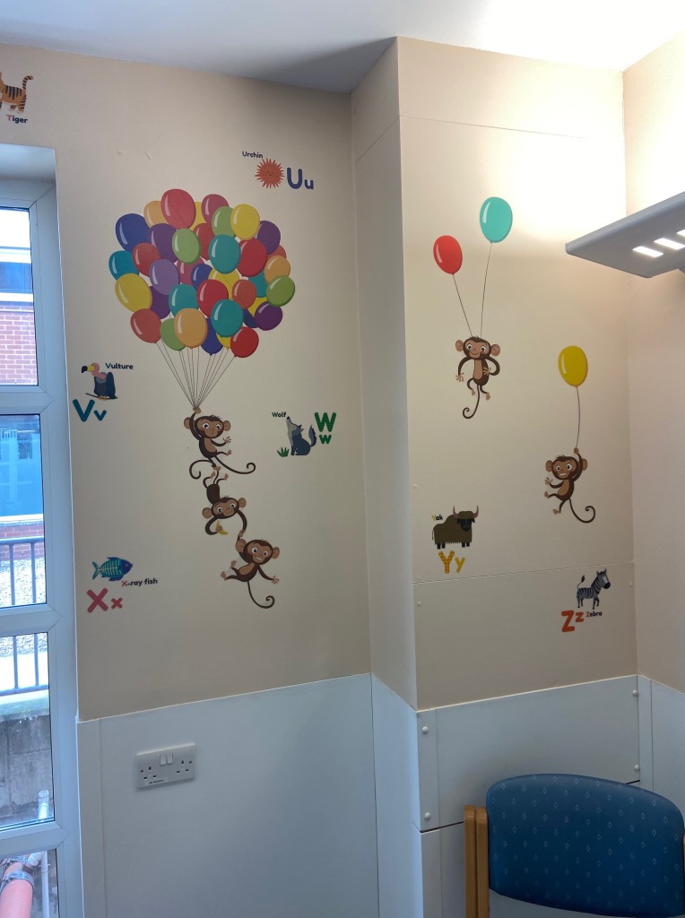 Example of the wall art in the waiting area which includes monkey's holding onto balloons